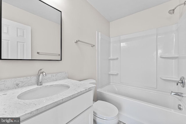 bathroom featuring toilet, vanity, and bathing tub / shower combination