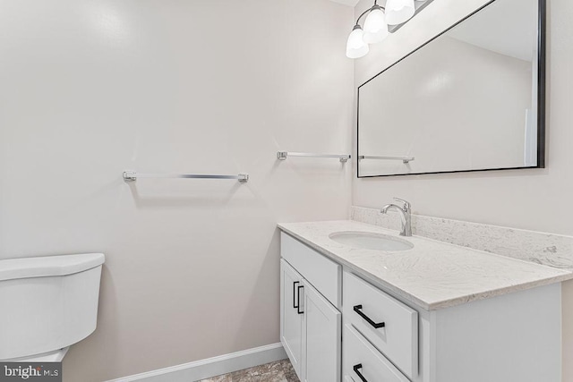 half bathroom with baseboards, toilet, and vanity