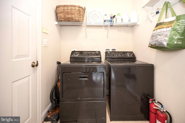 laundry area featuring washing machine and clothes dryer and laundry area
