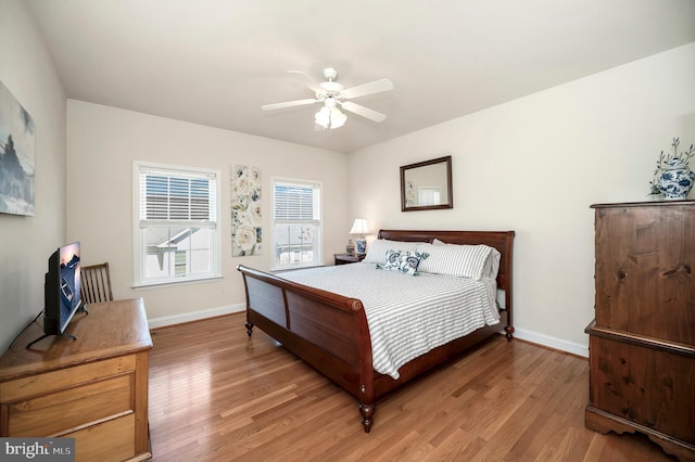 bedroom featuring baseboards, ceiling fan, and light wood-type flooring