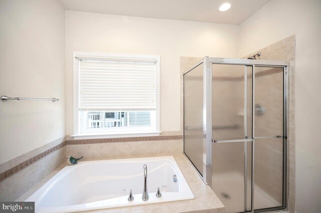 bathroom with a bath and a stall shower