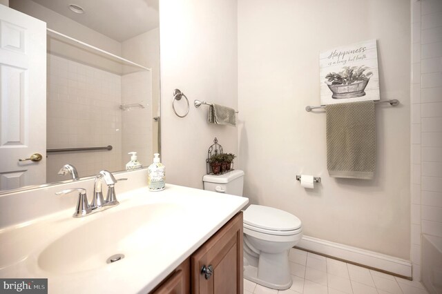full bathroom with tile patterned flooring, vanity, toilet, baseboards, and walk in shower