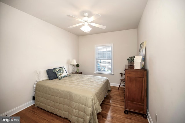 bedroom featuring baseboards, wood finished floors, and a ceiling fan