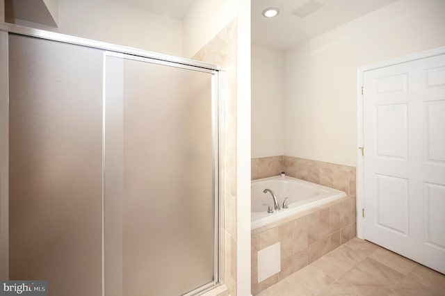 bathroom with a shower stall and a bath