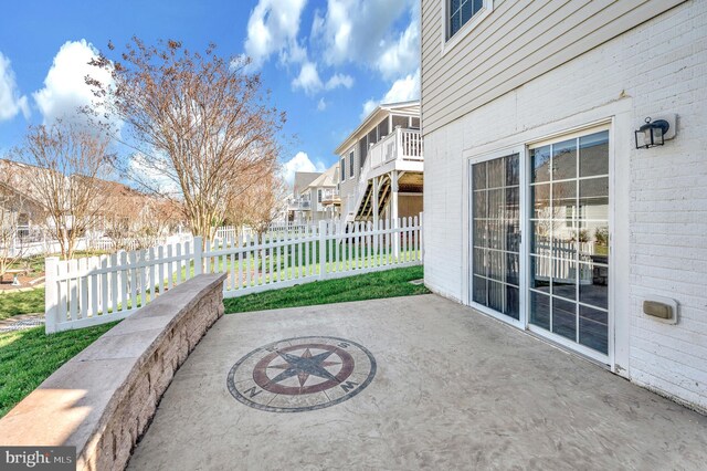 view of patio with a residential view and fence