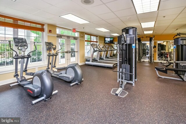 gym with baseboards, french doors, and a paneled ceiling
