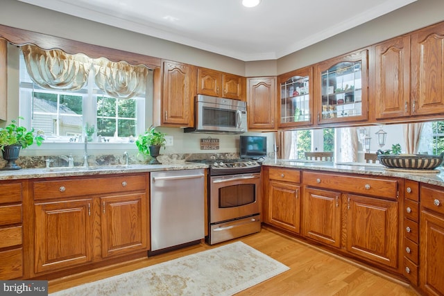 kitchen with appliances with stainless steel finishes and brown cabinetry