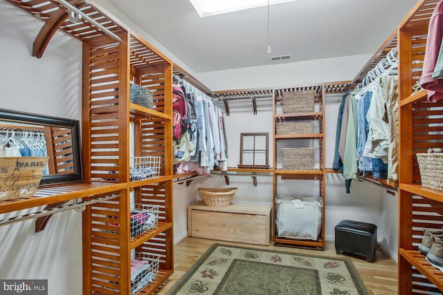 walk in closet with visible vents and wood finished floors