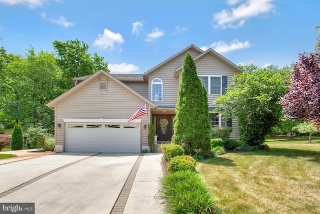 view of front facade with driveway, a garage, and a front yard
