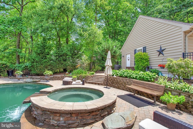 view of pool with a patio area, an in ground hot tub, and a fenced in pool