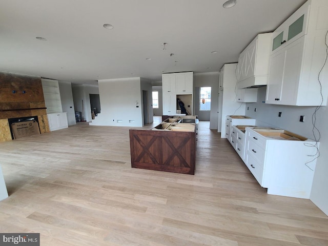 124 Primrose Ct, State College, PA 16801 - kitchen featuring open floor plan, white cabinets, light wood finished floors, and a fireplace