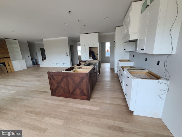 124 Primrose Ct, State College, PA 16801 - kitchen featuring a kitchen island with sink, light wood-type flooring, open floor plan, and white cabinetry