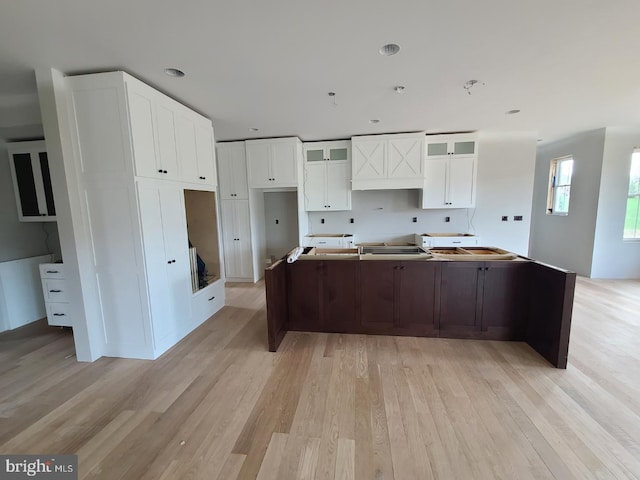 124 Primrose Ct, State College, PA 16801 - kitchen with glass insert cabinets, white cabinets, recessed lighting, a kitchen island, and light wood finished floors