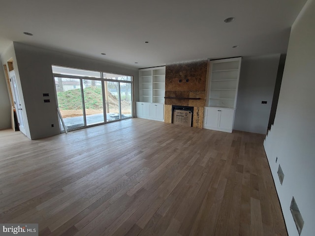 124 Primrose Ct, State College, PA 16801 - unfurnished living room featuring light wood-style flooring, a large fireplace, and built in shelves