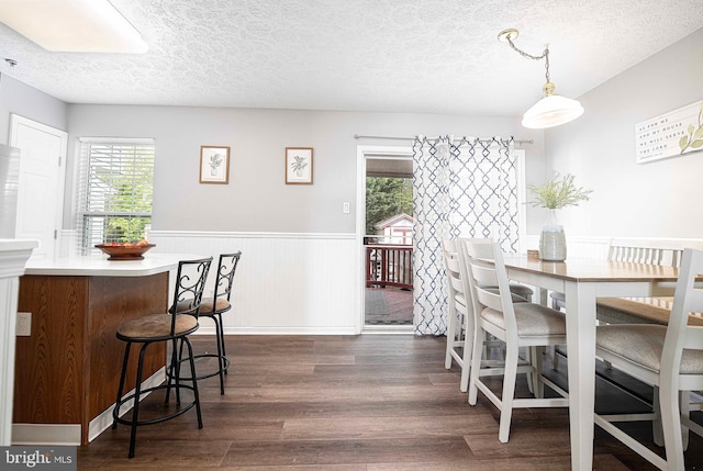 518 Macintosh Cir, Joppa, MD 21085 - dining area featuring wainscoting, a wealth of natural light, a textured ceiling, and dark wood-style flooring