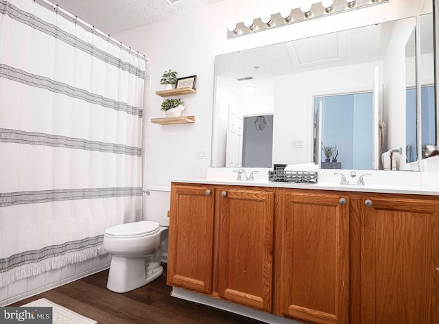 518 Macintosh Cir, Joppa, MD 21085 - bathroom featuring a textured ceiling, double vanity, visible vents, toilet, and wood finished floors