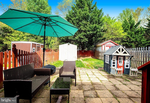 518 Macintosh Cir, Joppa, MD 21085 - view of patio featuring a storage unit, a fenced backyard, and an outbuilding