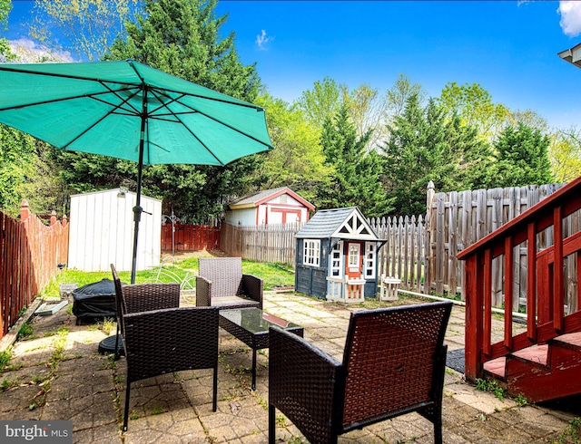 518 Macintosh Cir, Joppa, MD 21085 - view of patio featuring a storage unit, a fenced backyard, and an outdoor structure