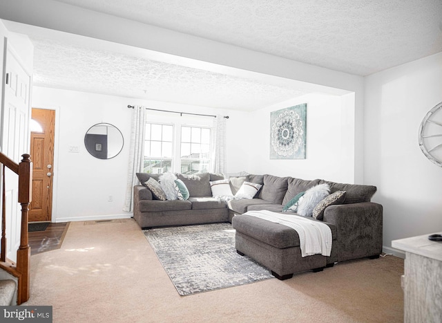 518 Macintosh Cir, Joppa, MD 21085 - carpeted living area with stairs, a textured ceiling, and baseboards