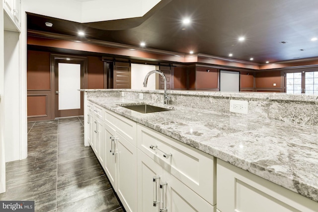 3325 Brandy Ct, Falls Church, VA 22042 - kitchen featuring a sink, crown molding, light stone counters, white cabinetry, and recessed lighting