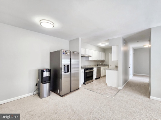 5900 Queenston St Unit 498, Springfield, VA 22152 - kitchen with light colored carpet, white cabinets, appliances with stainless steel finishes, under cabinet range hood, and baseboards