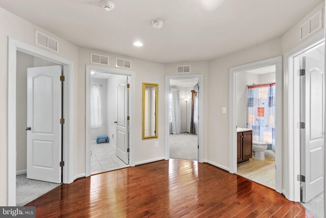 2710 Beech Orchard Ln, Upper Marlboro, MD 20774 - unfurnished bedroom featuring ensuite bath, wood finished floors, and visible vents