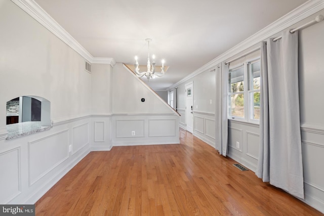 2220 Timothy Dr, Westminster, MD 21157 - unfurnished dining area with visible vents, ornamental molding, light wood-type flooring, and an inviting chandelier