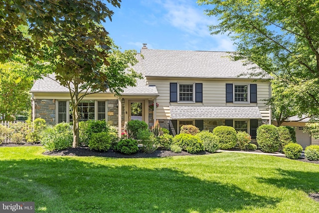 76 Deepdale Rd, Wayne, PA 19087 - tri-level home with stone siding, a front yard, and a shingled roof