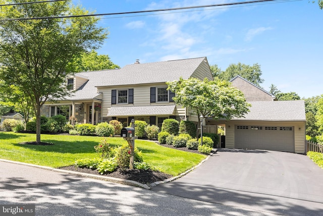 76 Deepdale Rd, Wayne, PA 19087 - tri-level home featuring driveway, an attached garage, a front yard, and stone siding