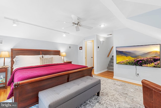 76 Deepdale Rd, Wayne, PA 19087 - bedroom with rail lighting, lofted ceiling, wood finished floors, and a ceiling fan