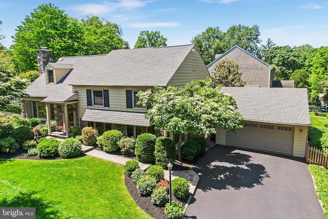 76 Deepdale Rd, Wayne, PA 19087 - view of front of home with a chimney, driveway, a garage, and roof with shingles