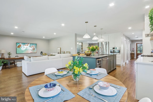 dining room with recessed lighting and light wood-style flooring