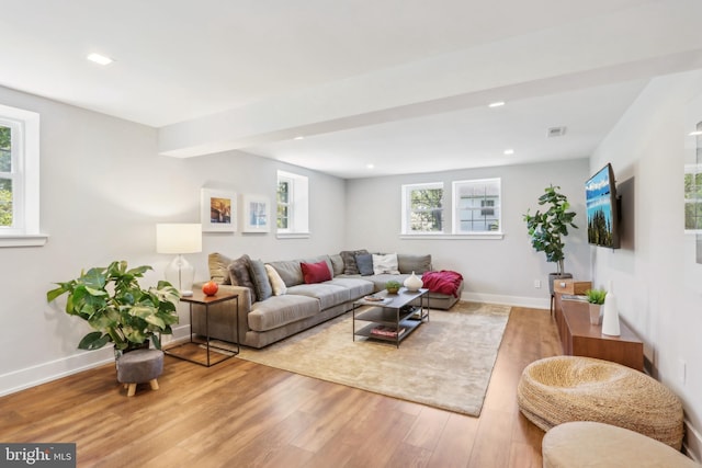 living area featuring baseboards, recessed lighting, wood finished floors, and visible vents