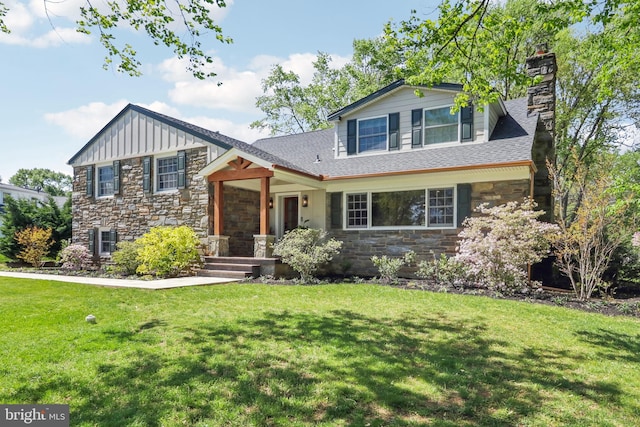 tri-level home featuring board and batten siding, a chimney, a front lawn, and stone siding