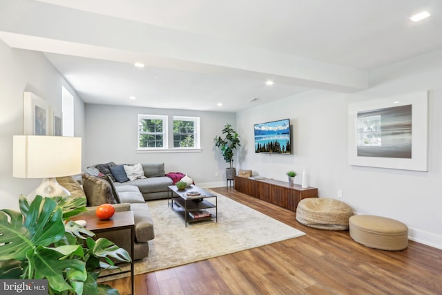 living room featuring recessed lighting, baseboards, and wood finished floors