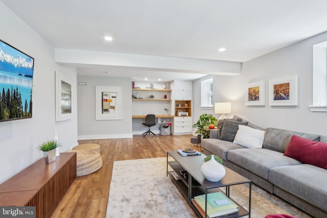 living area with recessed lighting, baseboards, and light wood-style floors