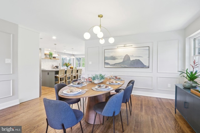 dining space with recessed lighting and wood finished floors