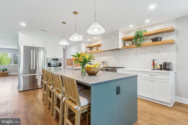 kitchen featuring open shelves, light wood-type flooring, white cabinets, backsplash, and stainless steel appliances