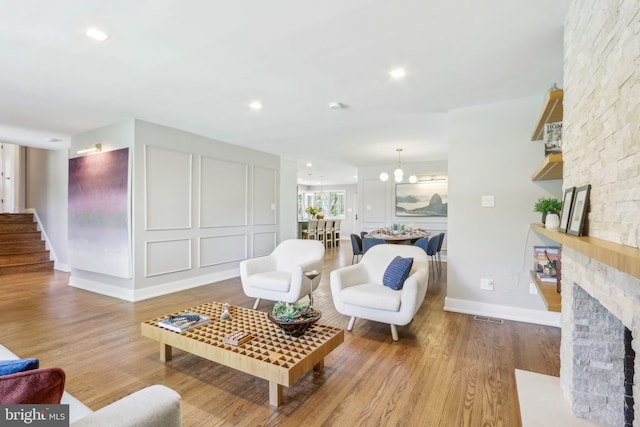 living room with baseboards, a fireplace, recessed lighting, and wood finished floors