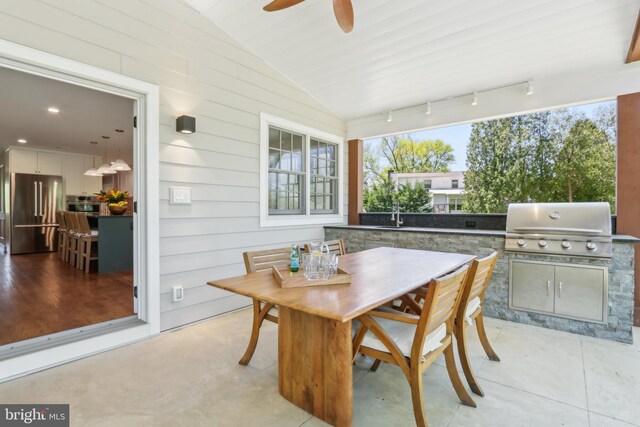 view of patio with grilling area, an outdoor kitchen, a ceiling fan, and outdoor dining area