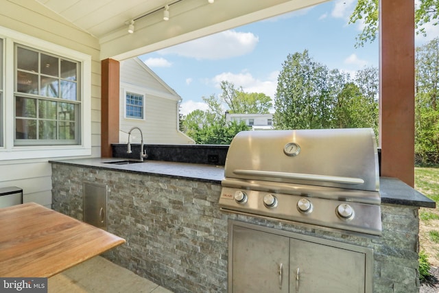 view of patio featuring a sink, a grill, and exterior kitchen
