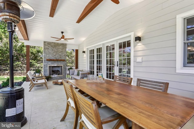 view of patio / terrace with french doors, ceiling fan, and an outdoor stone fireplace