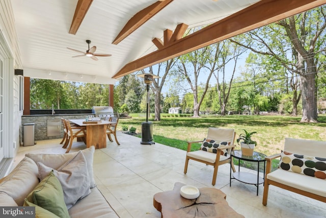 view of patio with ceiling fan, exterior kitchen, and area for grilling