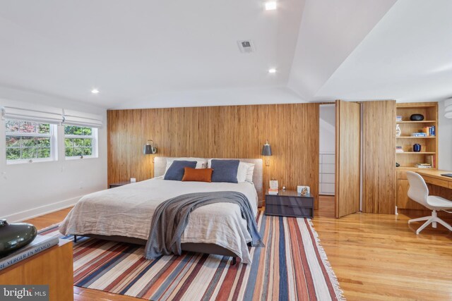 bedroom with recessed lighting, wood walls, visible vents, and light wood-type flooring