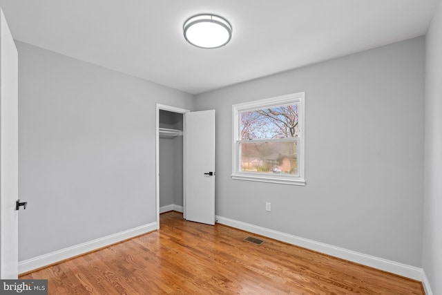 3605 Eyre Dr S, Upper Marlboro, MD 20772 - unfurnished bedroom featuring wood finished floors, a closet, baseboards, and visible vents