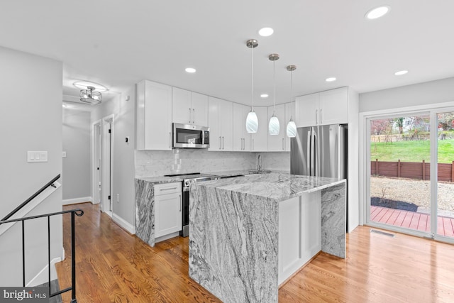 3605 Eyre Dr S, Upper Marlboro, MD 20772 - kitchen with white cabinets, a sink, stainless steel appliances, and decorative backsplash