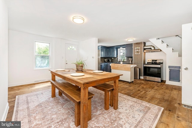 5431 Hines Rd, Frederick, MD 21704 - dining area featuring plenty of natural light, baseboards, light wood-style flooring, and stairs