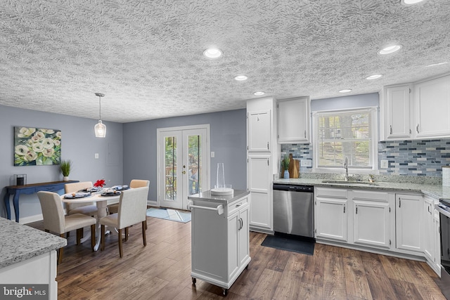 kitchen featuring dishwasher, white cabinetry, tasteful backsplash, and a sink