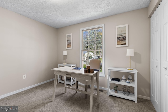 home office with baseboards, carpet flooring, and a textured ceiling