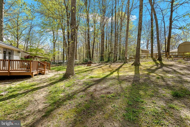 view of yard with fence and a deck